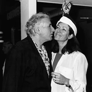 Jenny Seagrove Actress with Film Director Michael Winner kissing under a mistletoe