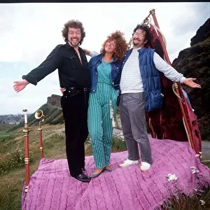 Jeremy Beadle TV presenter standing on bed with unknown couple