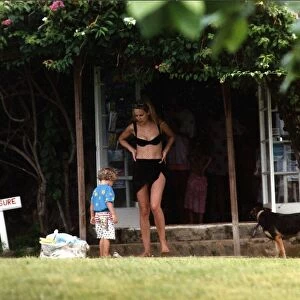 Jerry Hall Model in garden with her son James