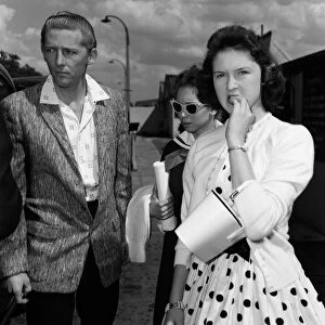 Jerry Lee Lewis and his 13-year-old wife Myra (centre) at London Airport to fly home