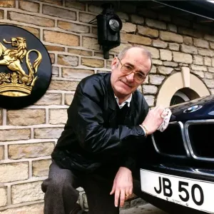 Jim Bowen Comedian / TV Presenter polishing his BMW car
