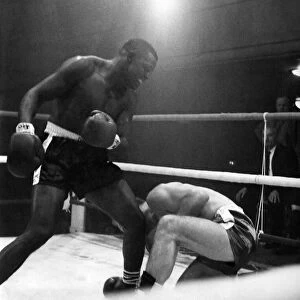 Jim Cooper goes down for a count of nine in the third round of his heavyweight fight