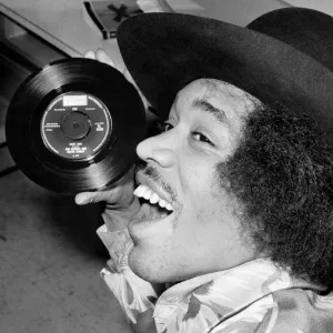 Jimi Hendrix with a copy of his new 7'release with Curtis Knight - Hush Now