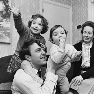 Jimmy Greaves plays with children Danny aged one and Mitzi, two. 31st January 1964