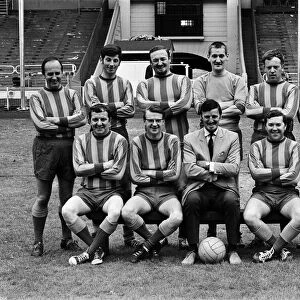 Jimmy Hill pictured (wearing a suit) with a football team