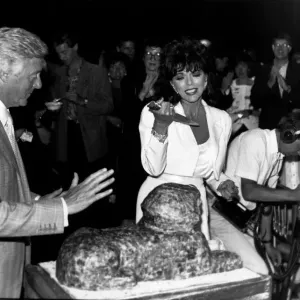 Joan Collins Actress frowning at cutting the cake in the shape of a Sphinx Joan Collins Actress frowning at cutting the cake in the shape of a Sphinx