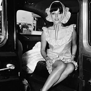 Joan Collins actress wearing a bonet