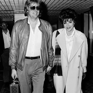 Joan Collins British actress arrives at Heathrow with husband Peter in April 1986