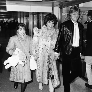 Joan Collins with daughter Katyana Kass and boyfriend Peter Holm at Heathrow after Joan Collins with daughter Katyana Kass and boyfriend Peter Holm at Heathrow after