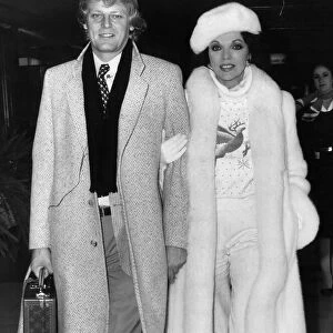 Joan Collins at Heathrow Airport with boyfriend Peter Holm. December 1984