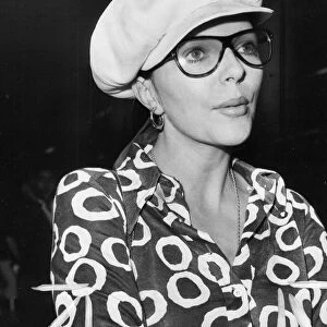 Joan Collins at London Airport wearing glasses and cap - August 1970