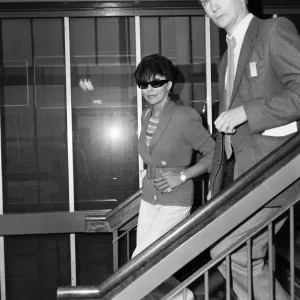 Joan Collins with her son Sacha, 17, arriving at Heathrow from Los Angeles Joan Collins with her son Sacha, 17, arriving at Heathrow from Los Angeles