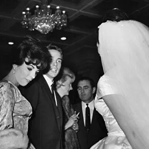 Joan Collins and Warren Beatty talking to Jackie Collins at her wedding - December 1960