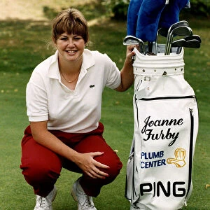 Joanne Furby Golf player crouching beside gold bag