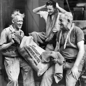 Print of a Merchant Navy stoker receiving a comfort item Print of a Merchant Navy stoker receiving a comfort item