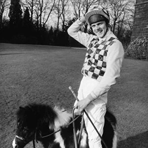 Jockey Simon Whitaker in his racing silks stands astride 21 inch high Bluebell