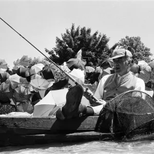 Joe Carver in a fishing boat with umbrellas, 8th July 1971 Print Joe Carver in a fishing boat with umbrellas, 8th July 1971 Print