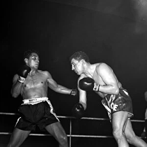 Joe Erskin of Wales throws a right at American Willie Pastrano when they met on the 24th