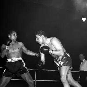 Joe Erskin of Wales throws a right at American Willie Pastrano when they met on the 24th