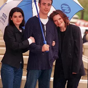 Joe McFadden with Shirley Henderson and Sharon Small standing under BBC umbrella