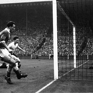 John Charles of Wales left scores against England in the international match between
