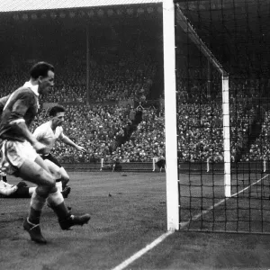 John Charles of Wales left scores against England in the international match between
