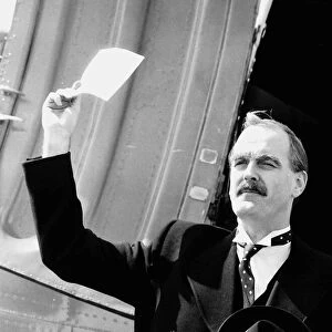 John Cleese Actor in a scene from a comedy show impersonating PM Chamberlain