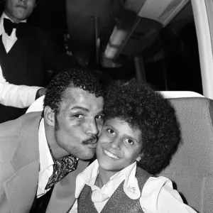 Print of John Conteh celebrating with family aboard a Playboy motor coach