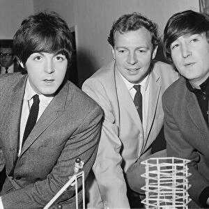 John Lennon and Paul McCartney of The Beatles with producer Johnny Hamp who booked