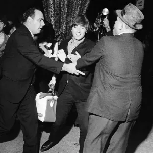 John Lennon and Paul McCartney escaping frenzied reporters at the Forest Hills Tennis John Lennon and Paul McCartney escaping frenzied reporters at the Forest Hills Tennis