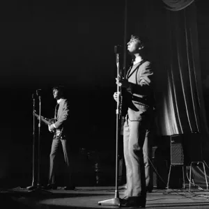 John Lennon and Paul McCartney onstage, during a Beatles gig at the Odeon Cinema