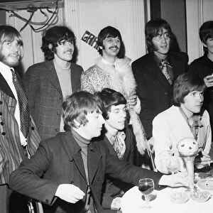 John Lennon and Ringo Starr of The Beatles (back row centre