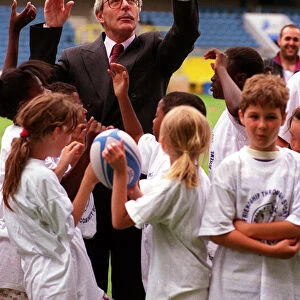 John Major MP Prime Minister tries his hand at the sport with schoolchildren during an