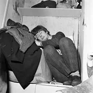 John Mayall of the Bluesbreakers, takes a nap in the band room between performances