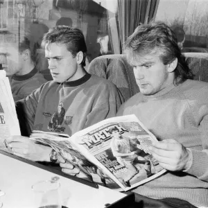 A black and white print of two footballers on a team coach A black and white print of two footballers on a team coach