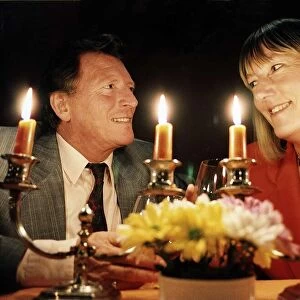 Johnny Briggs Actor with Hilary Bonner Daily Mirror Journalist dining by candlelight at