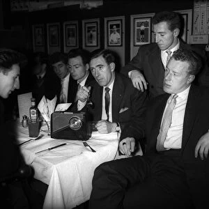 Johnny Brooks and other Tottenham Hotspur players sitting around table listening to