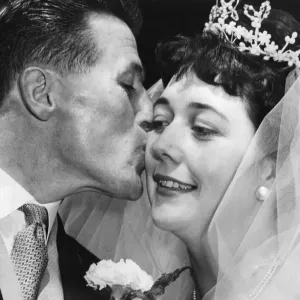 Johnny Dixon, Aston Villas long-service player, kisses his bride, Miss Brenda Fisher Johnny Dixon, Aston Villas long-service player, kisses his bride, Miss Brenda Fisher
