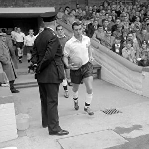 Johnny Haynes of Fulham leading his team out for a league division one match at Craven