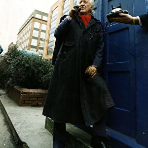 Jon Pertwee actor ex Dr Who leaning against police box like Tardis Glasgow talking
