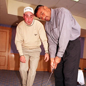 Jonah Lomu Rugby player October 1999 playing golf putting Receiving lesson from Kevin