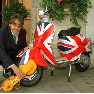 Jonathan Ross TV Presenter has his scooter clamped outside virgin radio this morning by