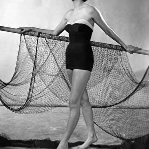 Jontzens sleek one-piece Nylon swimsuit shows the 1951 trend for the sea shore