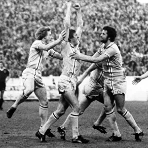 The joy of scoring... Tommy Hutchison, arms held high, is mobbed by delighted City
