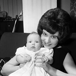 Joyce Wilde at home in Chiswick with her baby daughter Kim. 30th January 1961