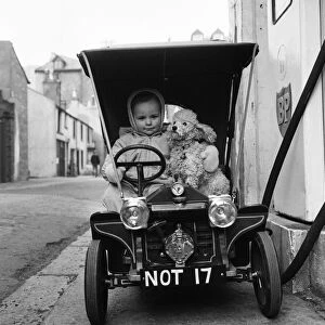 Judy Oliver in her vintage baby car. 1st March 1964