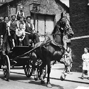 June 1957. Children riding on a cart drawn by a horse which was owned by Griffin