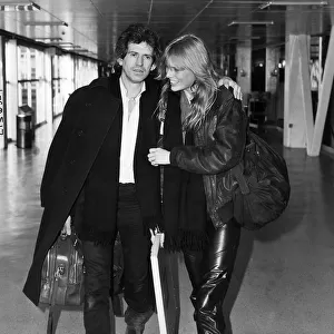 Keith Richards guitarist with the Rolling Stones leaving Heathrow with his girlfriend