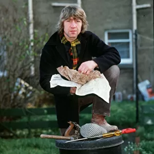 Ken Buchanan boxer 1983 eating fish and chips out of paper foot on dustbin cap tools