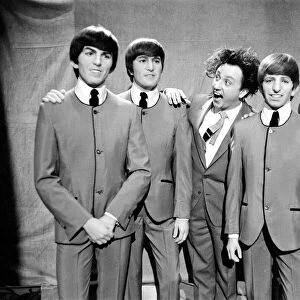 Ken Dodd (centre) posing with Madame Tussauds figures of The Beatles
